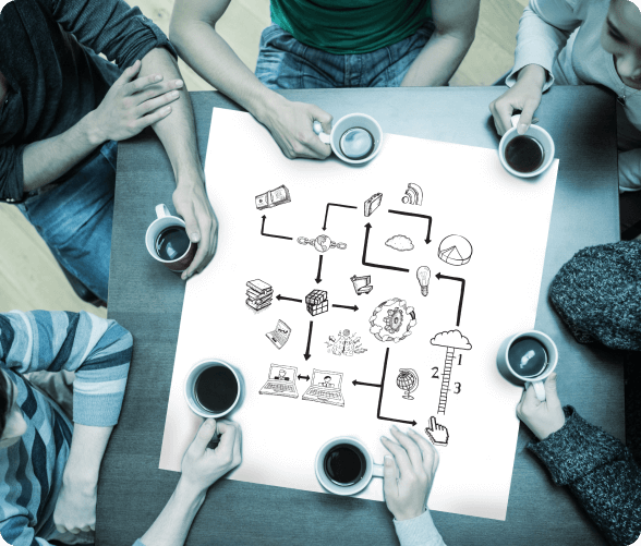 Several people gathered at a table, enjoying coffee and lively discussions in a warm, inviting atmosphere.