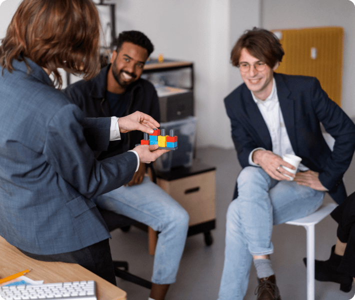 Several people gathered around a table, actively participating in discussion and sharing ideas in a collaborative setting.