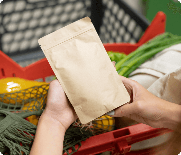 An individual is seen grasping a paper bag containing an assortment of vegetables, emphasizing wholesome food choices