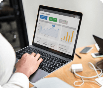 An individual engaged with a laptop, examining a graph that illustrates important data trends.