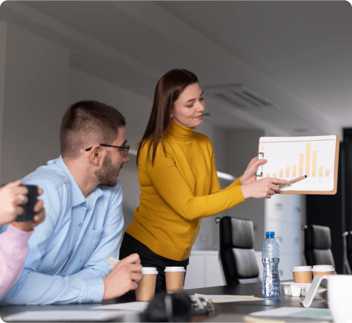 A woman delivers a presentation to a captivated audience, showcasing her ideas and insights effectively.