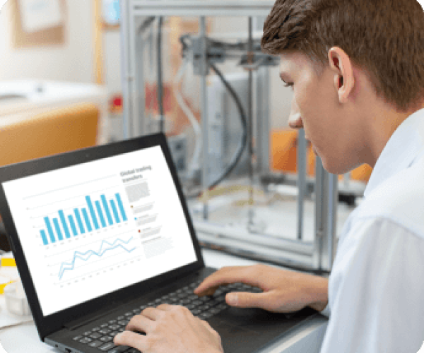 A man engaged with a laptop, reviewing graphs that illustrate data trends and performance metrics.